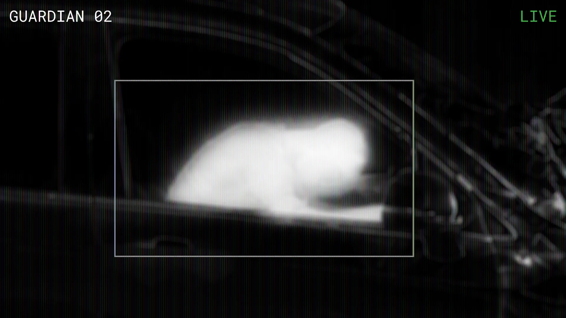 The drone's thermal view: a white-hot human signature slumped in the dark cabin of the wreck.
